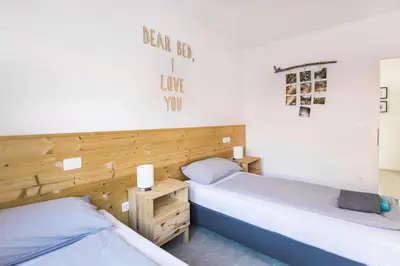 two beds sitting next to each other in a room at Positive sport apartments in Kobarid