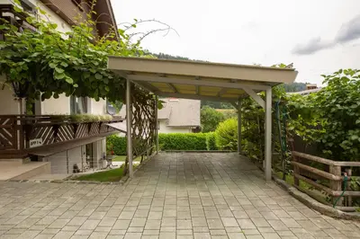 a patio with awning next to a building at Apartments Korošec in Bled