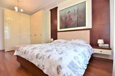 a bedroom with a bed and a painting on the wall at Vila Ključe Apartments in Bled