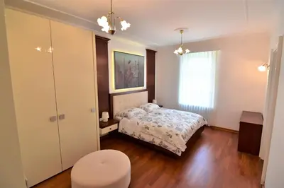 a small bedroom with a bed and a window at Vila Ključe Apartments in Bled