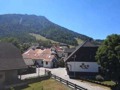 a village with houses and a mountain in the background at Apartma EVA&MATIC in Kranjska Gora