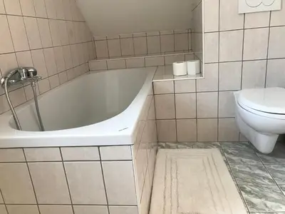 a bathroom with a white tub and a toilet at Apartma EVA&MATIC in Kranjska Gora
