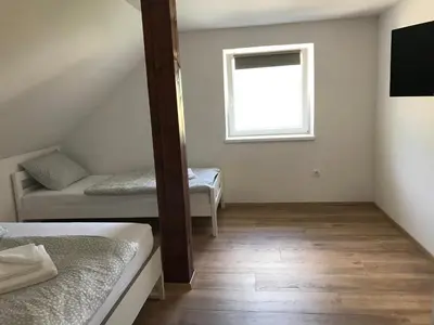 a room with two beds and a window at Apartma EVA&MATIC in Kranjska Gora
