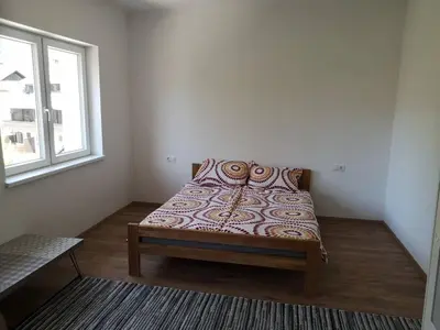 a bed in a room with a window at Apartma EVA&MATIC in Kranjska Gora
