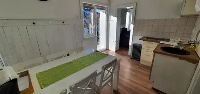 a kitchen with a table in the middle of a room at Apartma EVA&MATIC in Kranjska Gora