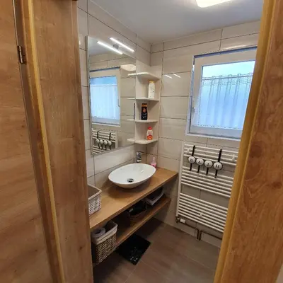 a small bathroom with a sink and a mirror at Apartments Mojstrana - Kekec in Mojstrana