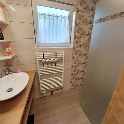 a bathroom with a sink and a window at Apartments Mojstrana - Kekec in Mojstrana