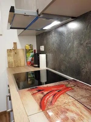 a kitchen with a counter with a red tool at Apartments Mojstrana - Kekec in Mojstrana