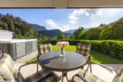 a table with a vase of flowers on a patio at Chilly apartment in Bled