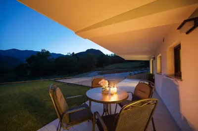 a table and chairs on a patio with a view at Chilly apartment in Bled