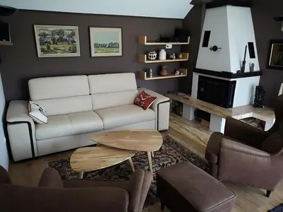 a living room with a couch and a table at Holiday House Red Deer in Preddvor