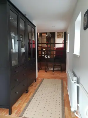 a living room with a black cabinet and a rug at Holiday House Red Deer in Preddvor