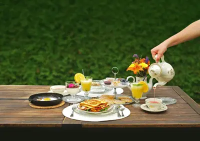 a table with a breakfast of pancakes and orange juice at Hiša Poljana Rooms in Prevalje