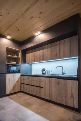 a kitchen with wooden cabinets and a sink at Residence Novak Bohinj in Bohinj