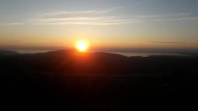 a sunset on the top of a mountain at APARTMAJI MATAŽIN in Črni Kal