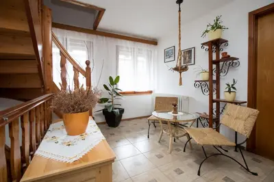 a room with a staircase and a table and chairs at Sobe Odar Andrej in Bohinj