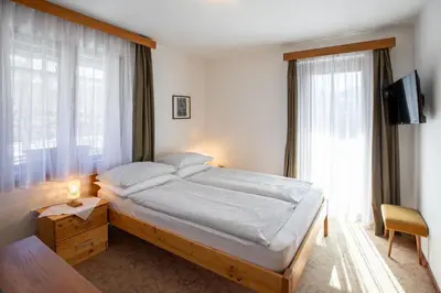a bedroom with a bed and a large window at Sobe Odar Andrej in Bohinj