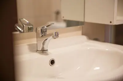 a bathroom sink with a faucet and a mirror at Apartma Natura Kope in Šmartno pri Slovenj Gradcu