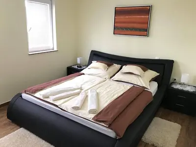 a bed with white sheets and pillows in a bedroom at Vinska klet Seršen in Dobrovnik