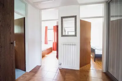a room with a hallway with a mirror and a door at Hisa Smast in Kobarid