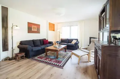 a living room with a couch and a table at Hisa Smast in Kobarid