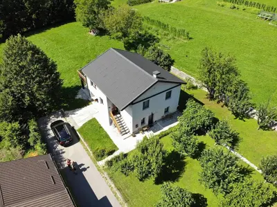 an aerial view of a white house with a car at Hisa Smast in Kobarid