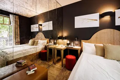 a hotel room with a bed and a desk at Boutique Hotel Sunrose 7 - Gourmet & SPA in Bohinj