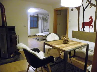 a living room with a table and chairs and a couch at InGreen house in Bohinjska Bela