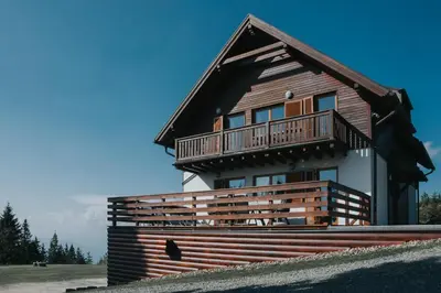 a house with a balcony on the side of it at Apartmaji Mara in Ribnica na Pohorju