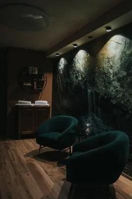 a room with two chairs and a painting on the wall at Apartmaji Mara in Ribnica na Pohorju