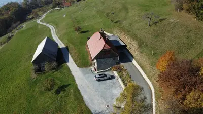 a car parked in front of a house on a hill at Vacation House Donacka Gora in Rogatec