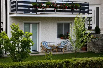 a patio with two chairs and a table on a balcony at Apartma MAELL 1 in Most na Soči