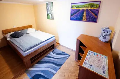a small bedroom with a bed and a table at APARTMA JAKOPIČ in Zgornje Gorje