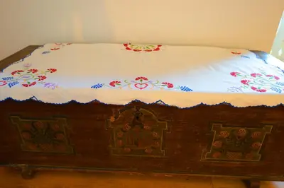 a wooden bed with flowers on top of it at Apartmaji Pekovec Bohinj in Bohinj