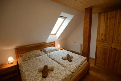 a bedroom with a bed with two brown teddy bears on it at Apartmaji Pekovec Bohinj in Bohinj