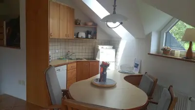 a kitchen with a table with chairs and a sink at JULIJA 3 SUNNY APPARTMENT in Kranjska Gora