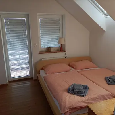 a bedroom with a bed with two towels on it at JULIJA 3 SUNNY APPARTMENT in Kranjska Gora
