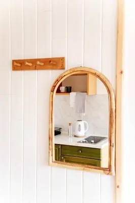 a mirror hanging on a wall with a sink at Ana Antloga Apartments in Bled