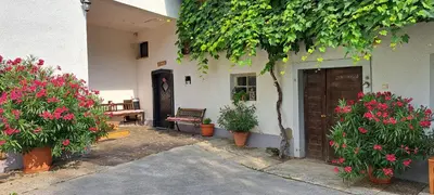 a courtyard with flowers and a bench and a building at Ana Antloga Apartments in Bled