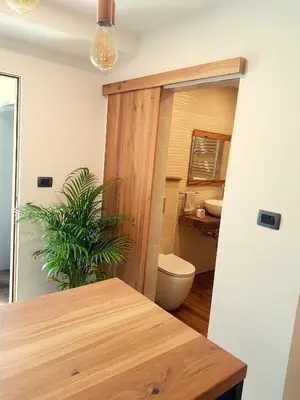 a room with a table and a toilet and a bathroom at Wine cellar room in Vipava