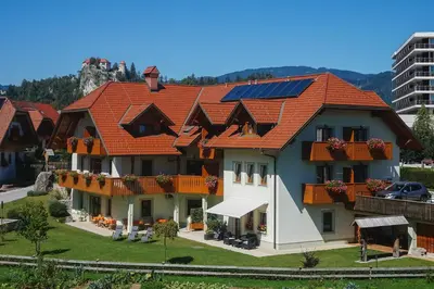 a house with an orange roof with solar panels on it at Penzion Kaps in Bled