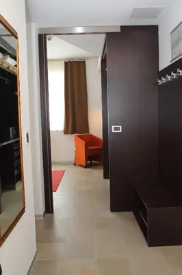 a hallway with a mirror and a couch in a room at Klass 103 in Kranjska Gora