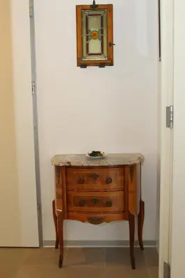 a wooden dresser with a mirror on a wall at Klass 103 in Kranjska Gora