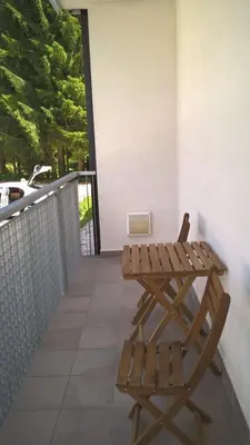 a wooden bench and a table on a balcony at Klass 103 in Kranjska Gora