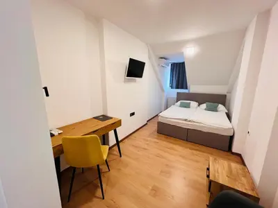 a small room with a bed and a desk at Kozjanski dvor in Podčetrtek