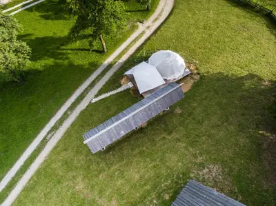 an overhead view of a park with two umbrellas at PUŽMAN Farm Glamping in Radovljica