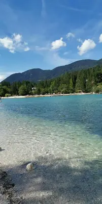 a large body of water with mountains in the background at Kranjska Gora Family Break in Kranjska Gora