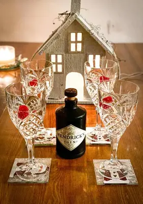 a table with three wine glasses and a house at Kranjska Gora Family Break in Kranjska Gora