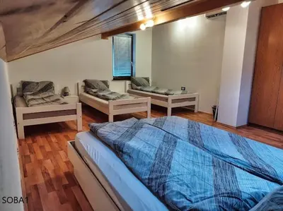 a bedroom with two beds in a room at Rooms pr zajčku in Tolmin