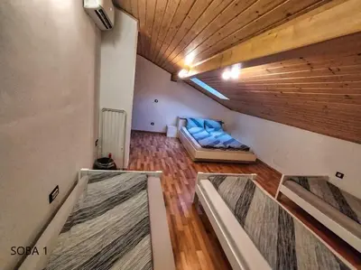 a living room with a couch in a room at Rooms pr zajčku in Tolmin